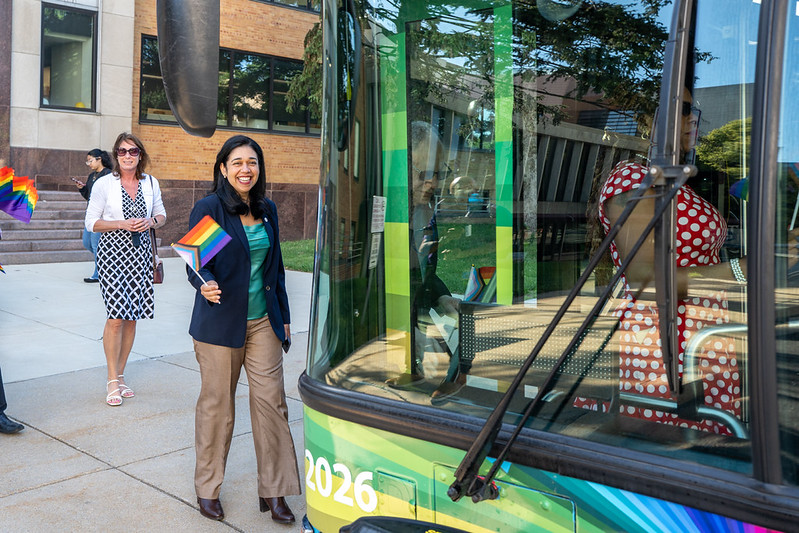 Council President Fani-González holds a Pride flag while walking onto the MCDOT Ride With Pride Ride On Bus.