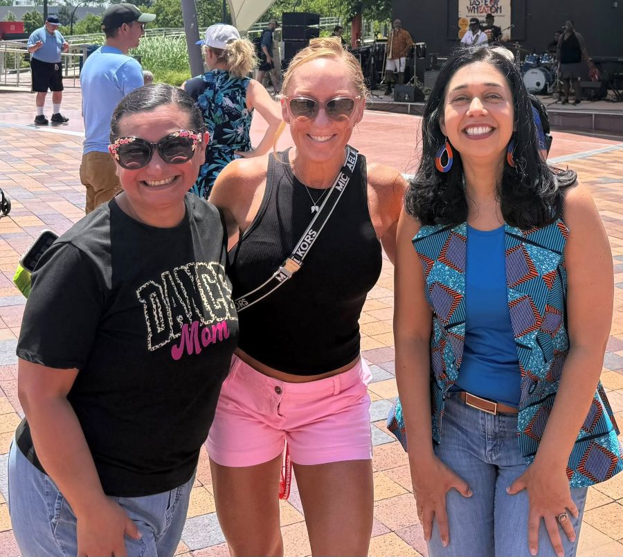Council President Fani-González with 2 community members in front of the Taste of Wheaton music stage.